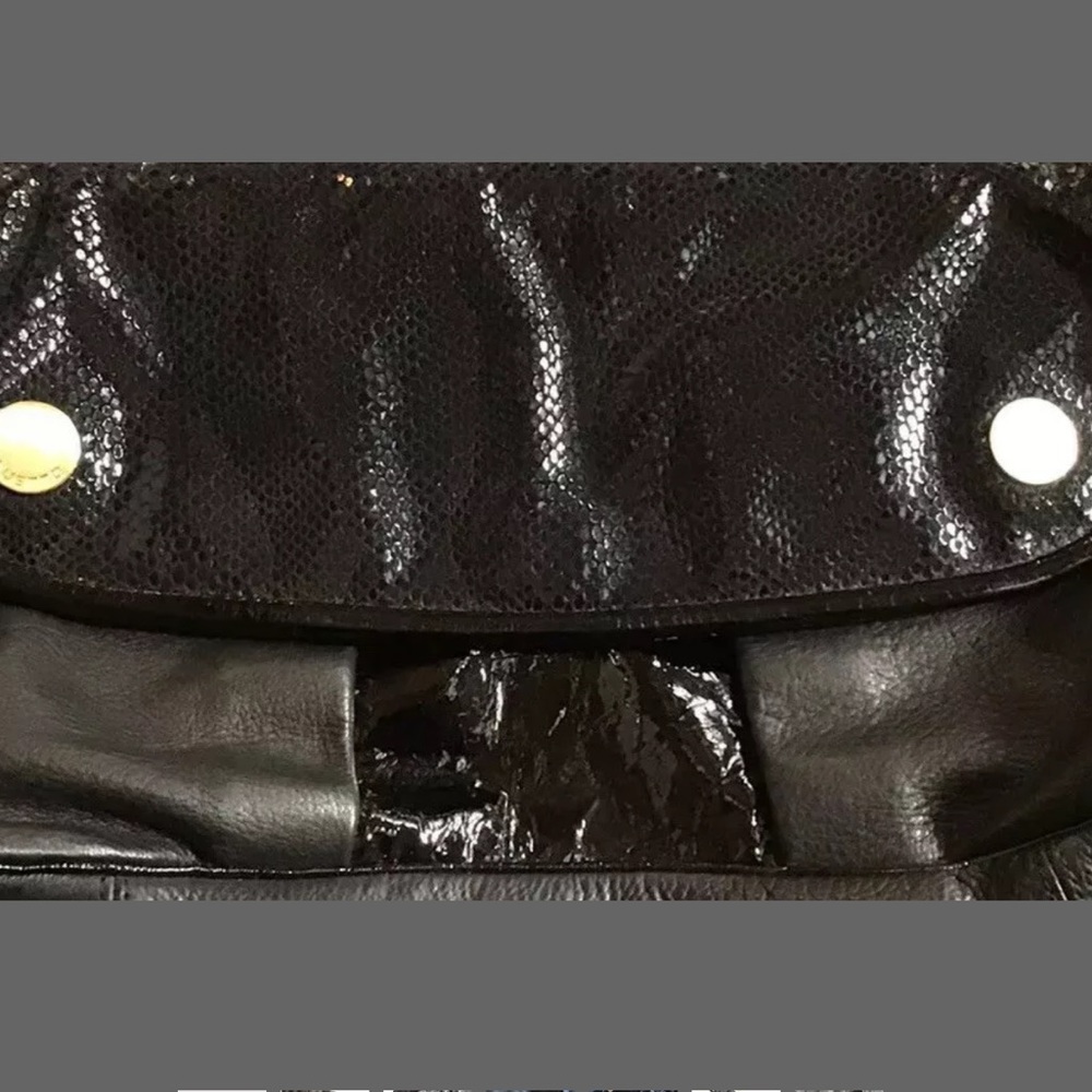 Gustto embossed suede and leather black clutch.